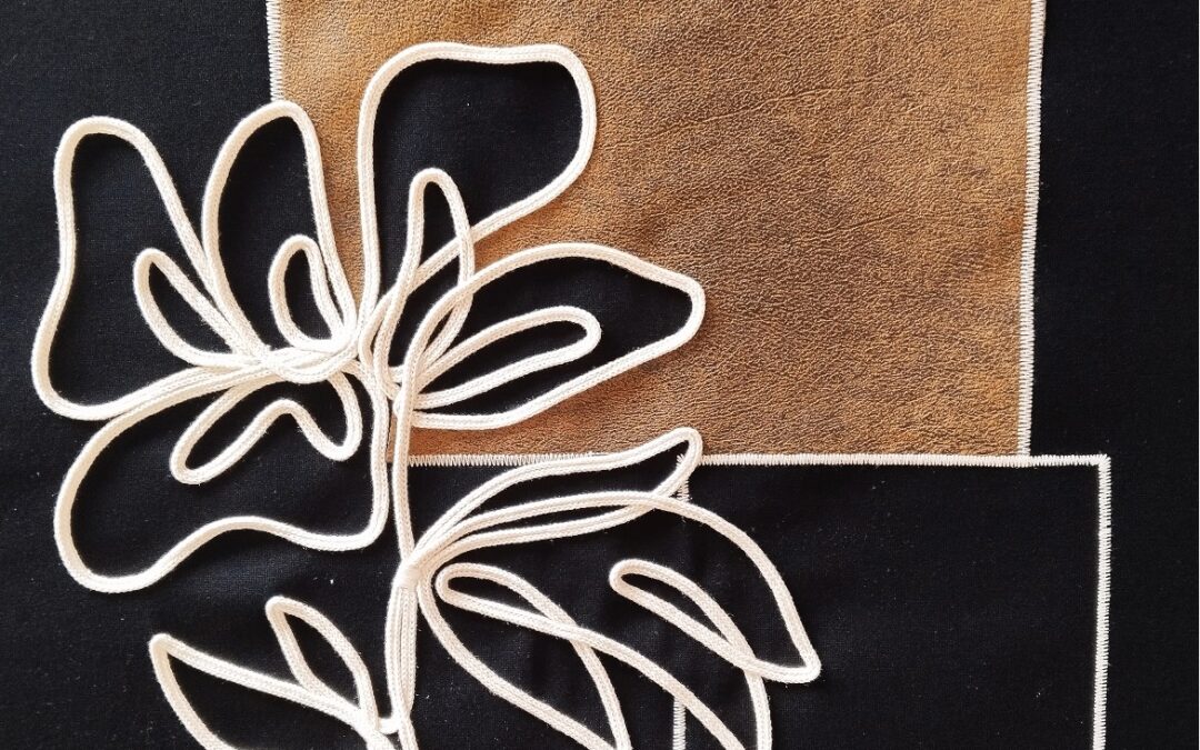 Bordado con aplicación y flor en cordón